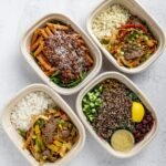 pasta millets cheeses meat rice veggies chutneys all food items in tiffin box.